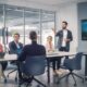 A group of new employees in a corporate training room during a video call.