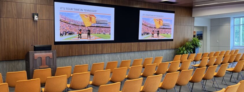 A modern conference room with a display.