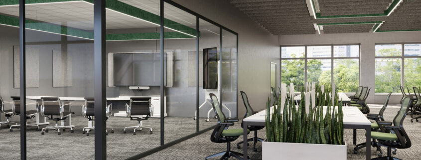 An open office space with a video conference room with glass walls and a large display.